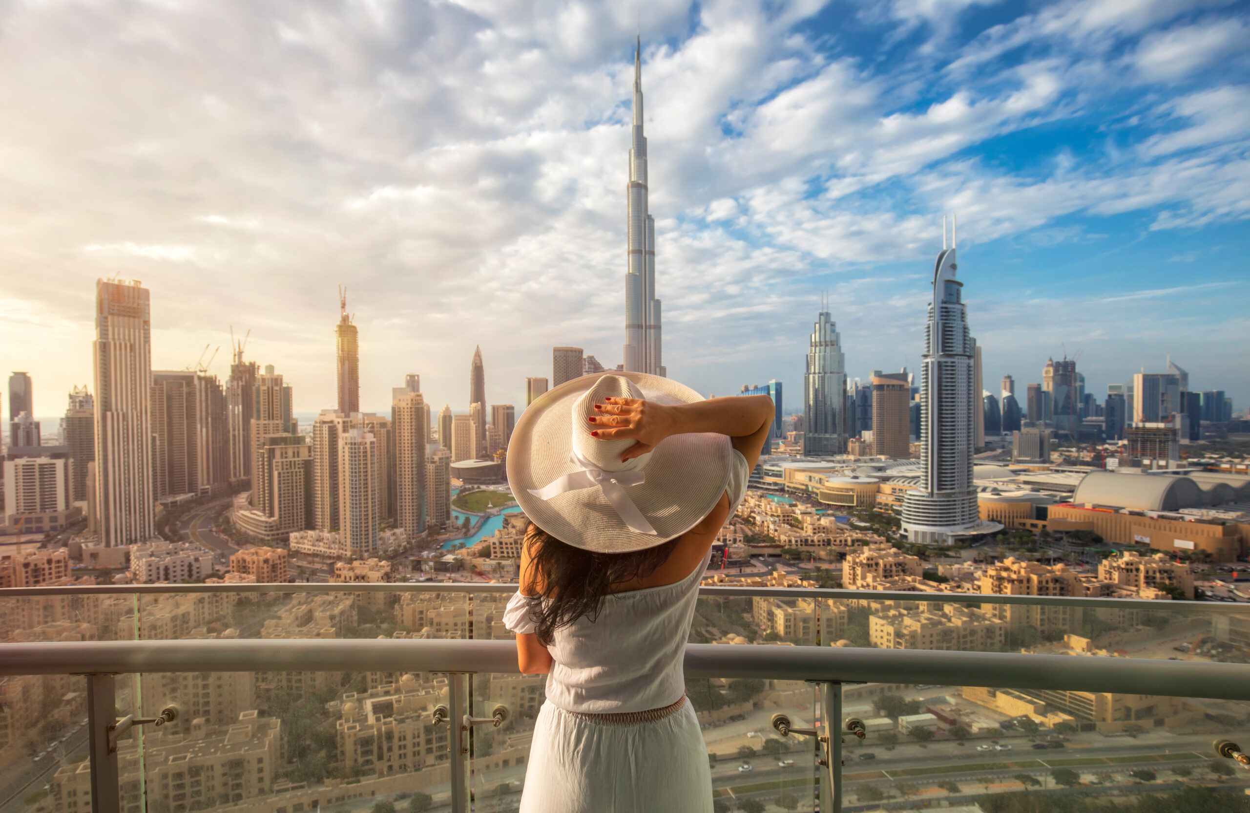 Woman,With,A,White,Hat,Is,Standing,On,A,Balcony